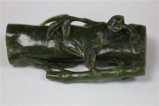 A Chinese archaistic white jade rhyton and a spinach green jade vase, 18th/19th century, H. 11cm and 8.5cm